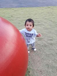 High angle portrait of smiling boy on field