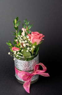 Close-up of pink flower vase against black background