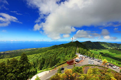 Scenic view of mountains and sea against blue sky