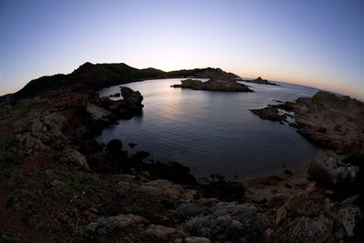 Scenic view of sea against clear sky during sunset