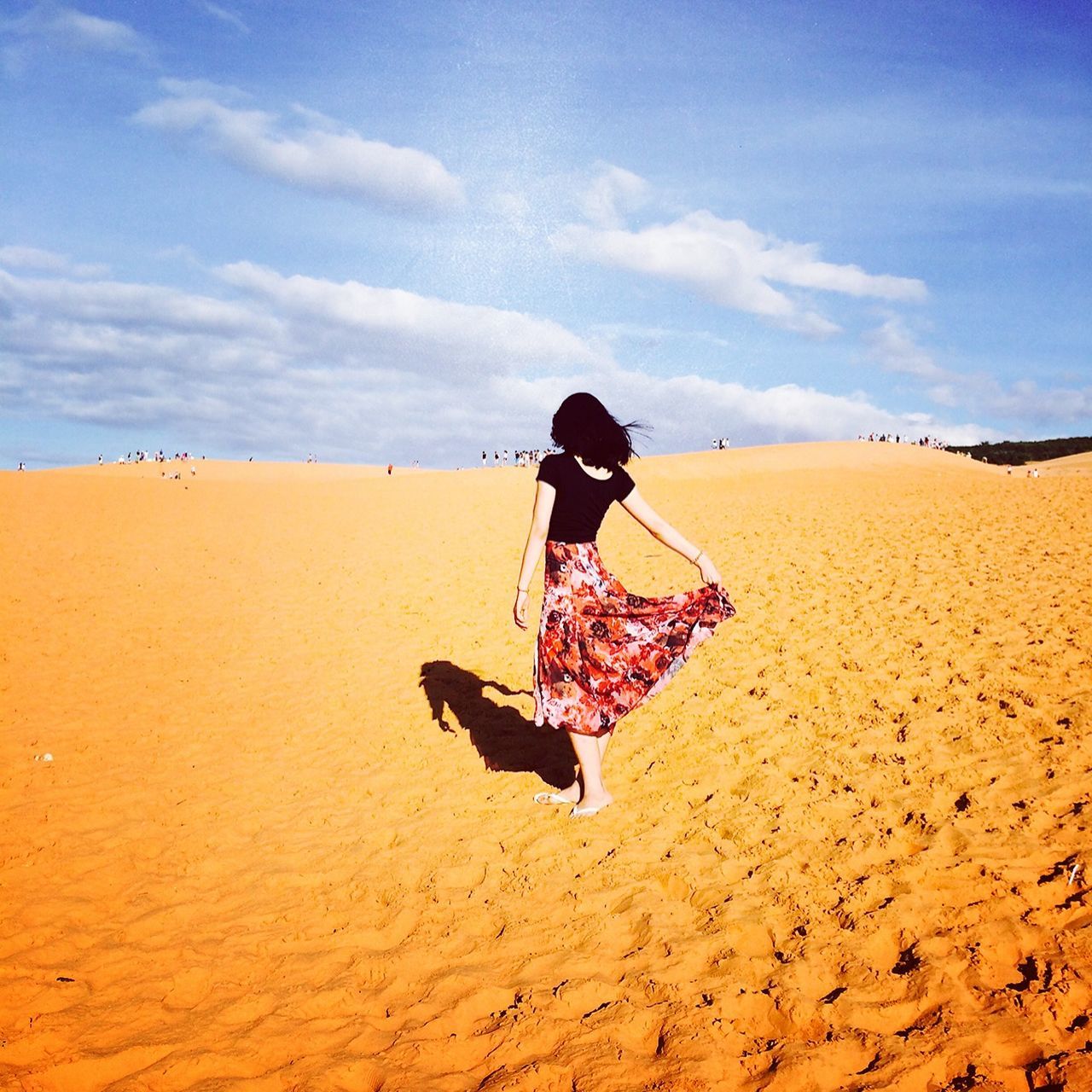 sand, beach, lifestyles, sky, full length, leisure activity, rear view, desert, casual clothing, vacations, tranquil scene, tranquility, person, men, shore, beauty in nature, sand dune, scenics