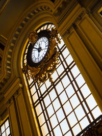 Low angle view of clock on window at railroad station