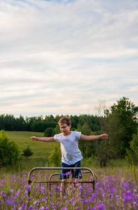 Full length of kid on meadow against sky