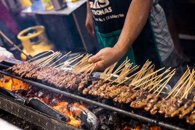 Man preparing food on barbecue grill