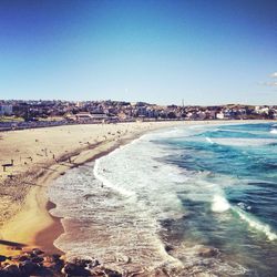 View of cityscape against clear blue sky