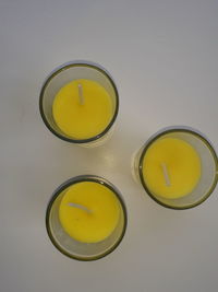 High angle view of yellow drink on table