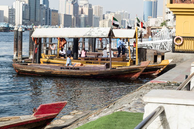 Boats moored at harbor in city