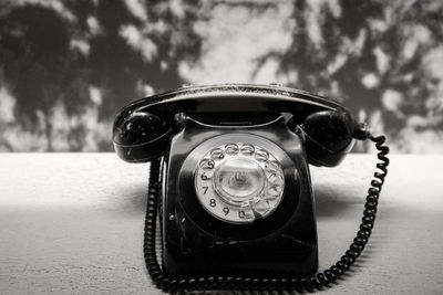 Close-up of telephone on table