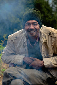 Portrait of a smiling man sitting outdoors