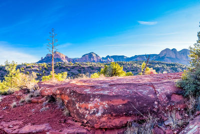 Scenic view of mountains against blue sky