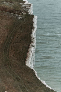 High angle view of rocks on shore at sea