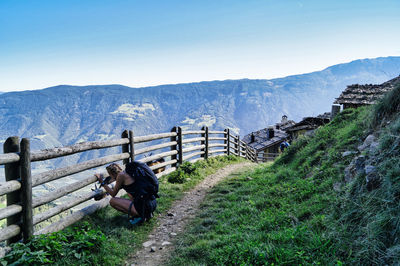 Scenic view of field, mountains, barrier and landscape against sky, naturno