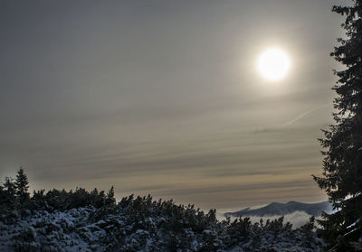 Scenic view of snow covered mountains against sky during sunset