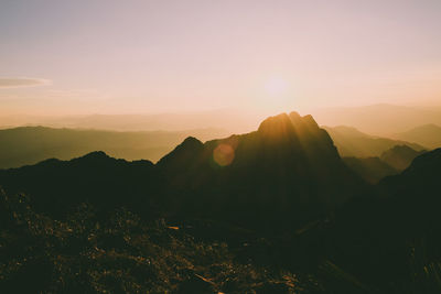 Scenic view of silhouette mountains against sky during sunset