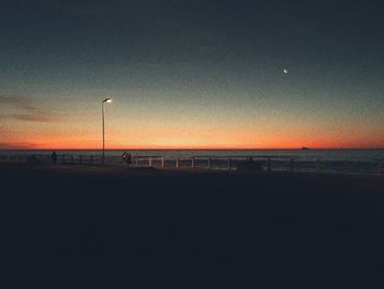 Scenic view of sea against clear sky at sunset