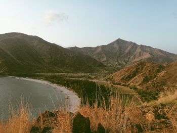 Scenic view of lake and mountains against sky