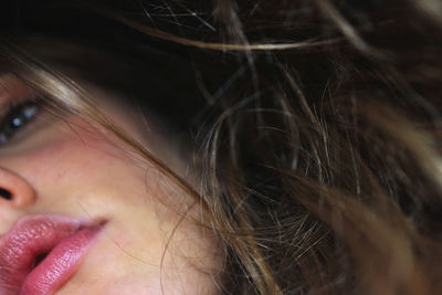 Close-up portrait of young woman with pink lipstick