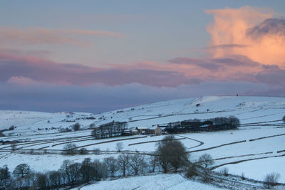 Snow covered landscape against sky