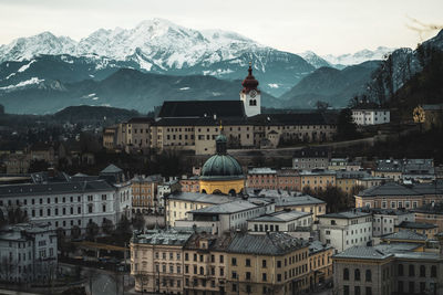 High angle view of townscape and mountains against sky