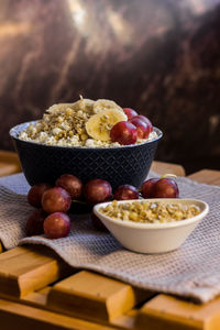 A plate of cottage cheese with granola, grapes and banana. healthy and delicious food for breakfast. 