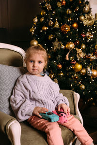 Little child girl having fun and relaxing at home. xmas and new year concept