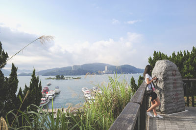 Panoramic view of boats in calm lake against mountain range