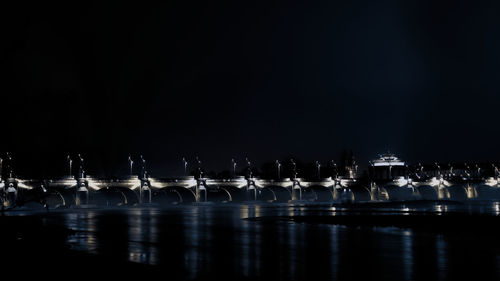 Close-up of row of water against black background