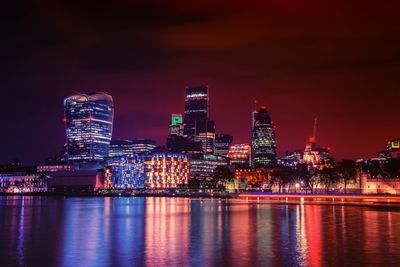 River with illuminated buildings in distance