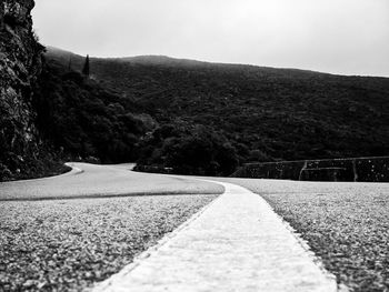 Empty road leading towards mountains