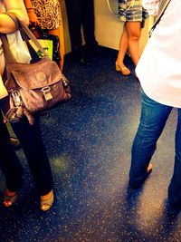 Low section of woman standing on tiled floor