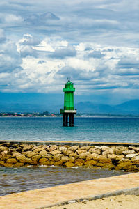 Lifeguard hut on beach against sky