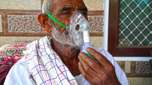Portrait of man holding umbrella
