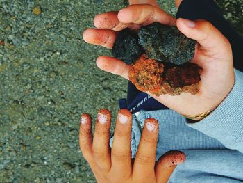 Cropped image of hand holding sunglasses