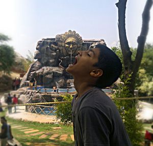 Portrait of young man statue against blurred background