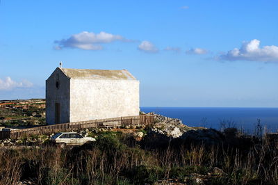 Castle by sea against sky