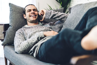 Young man resting on sofa