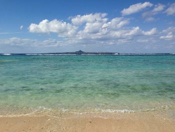 Scenic view of sea against cloudy sky