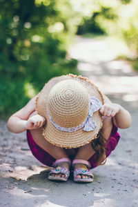 Low section of woman wearing hat