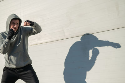 High angle view of woman standing against wall