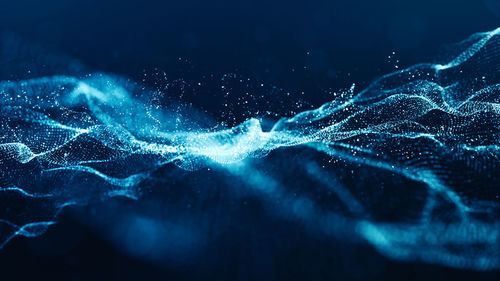 Close-up of water splashing against blue background