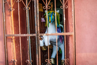 Close-up of multi colored door knocker on wall