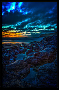 Scenic view of sea against cloudy sky