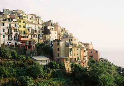 Buildings in town against clear sky