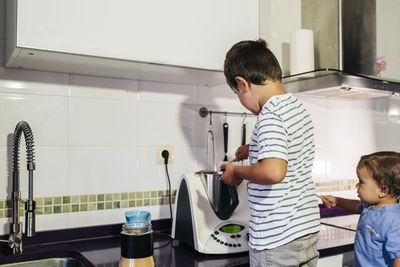 People standing in kitchen at home