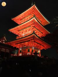 Illuminated temple against sky at night