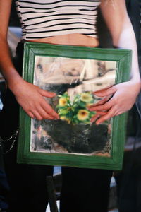 Midsection of woman holding fish