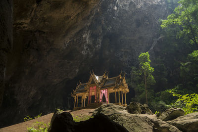 View of temple amidst rocks and building