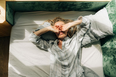 High angle view of woman standing on bed