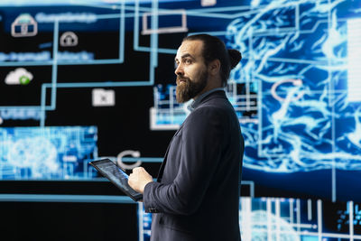 Side view of businessman using digital tablet