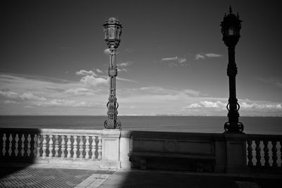 Street light by sea against sky